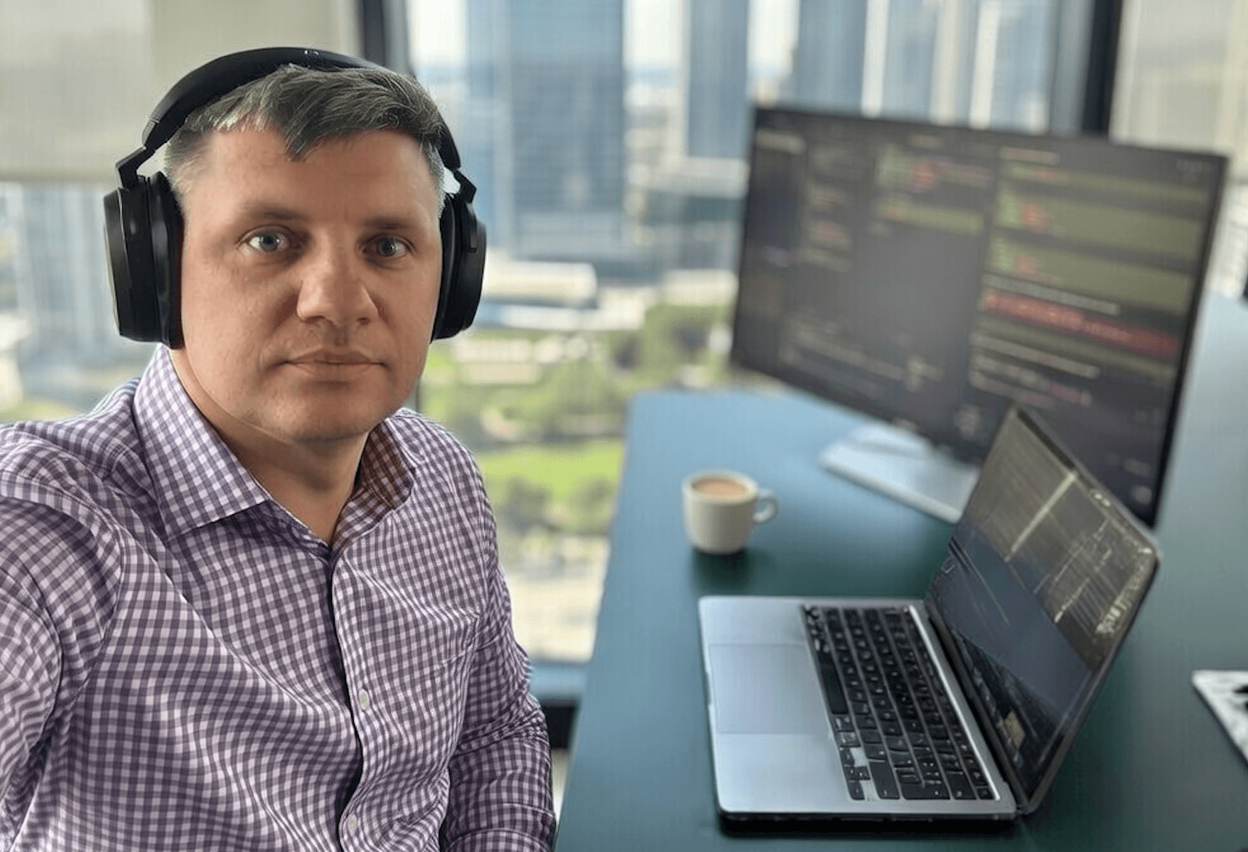 Founder working from a desk with development screens
